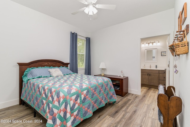 bedroom featuring ensuite bath, wood-type flooring, and ceiling fan