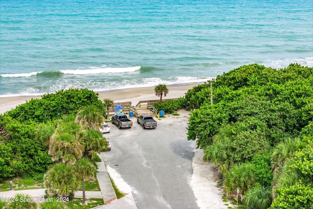 drone / aerial view with a water view and a beach view