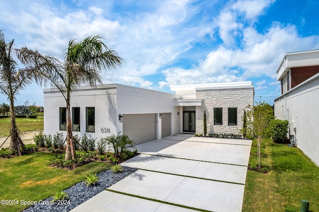 view of front of home with a front lawn and a garage