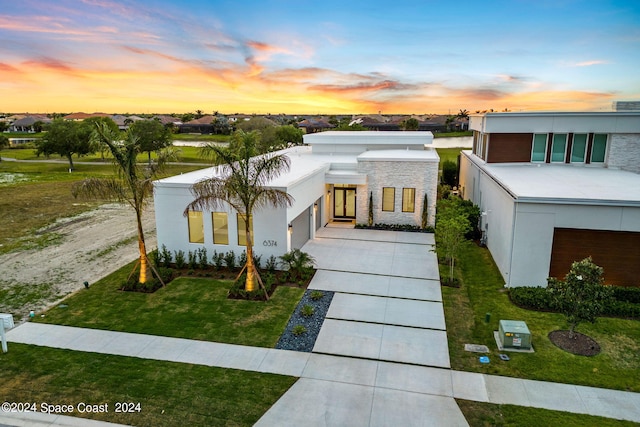 contemporary home with a yard and a garage