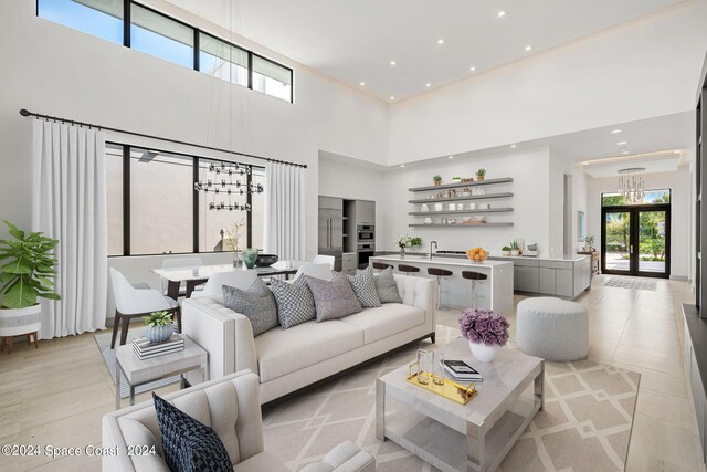 living room with french doors and a towering ceiling