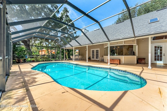 view of swimming pool with a lanai, a patio, and french doors