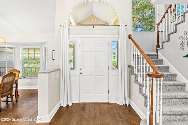 1150 Old Parsonage Dr, Merritt Island, FL 32952 - entryway featuring baseboards, stairway, dark wood-style flooring, and vaulted ceiling