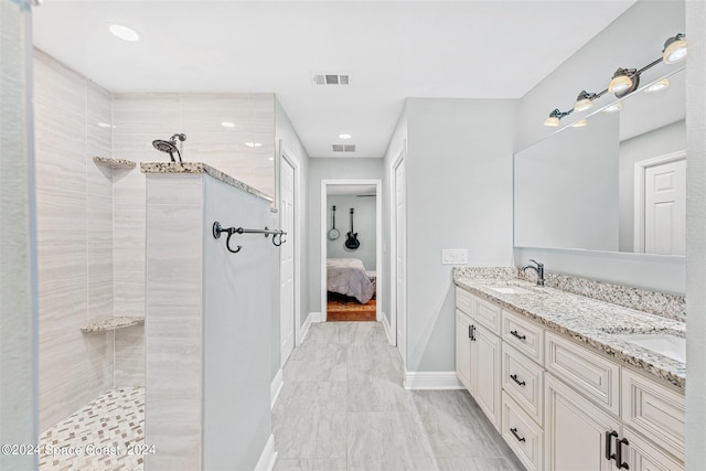 bathroom featuring vanity and a tile shower