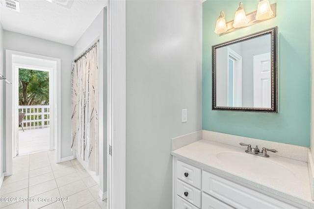 bathroom featuring tile patterned flooring and vanity