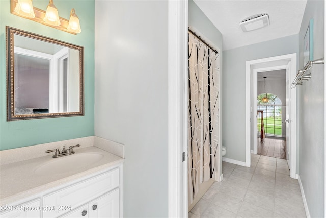 1150 Old Parsonage Dr, Merritt Island, FL 32952 - full bathroom with visible vents, baseboards, toilet, tile patterned floors, and vanity