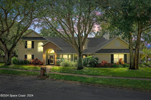 1150 Old Parsonage Dr, Merritt Island, FL 32952 - traditional-style house featuring a chimney, a yard, and a shingled roof