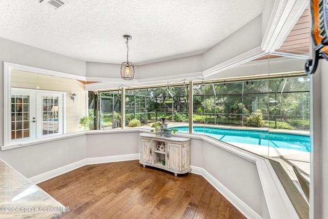 view of swimming pool with french doors