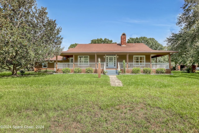 view of front of property with a front lawn and covered porch