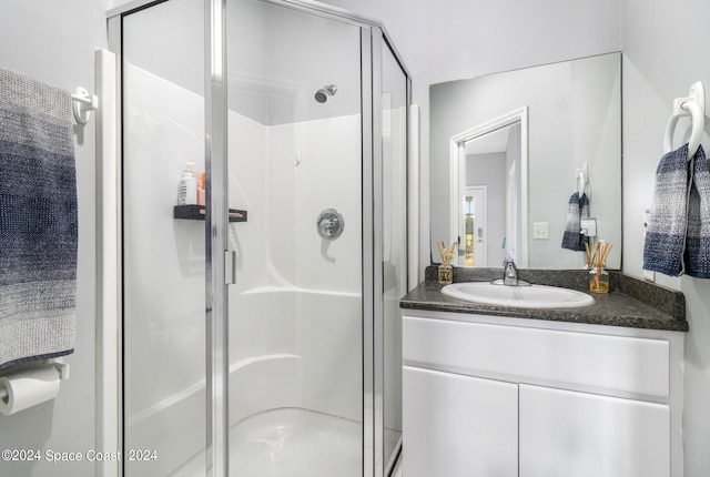 full bathroom featuring a shower stall and vanity