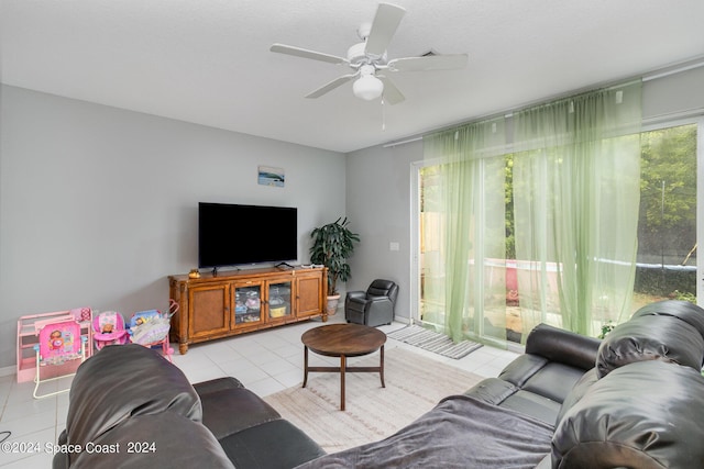 living room featuring light tile patterned floors and a ceiling fan