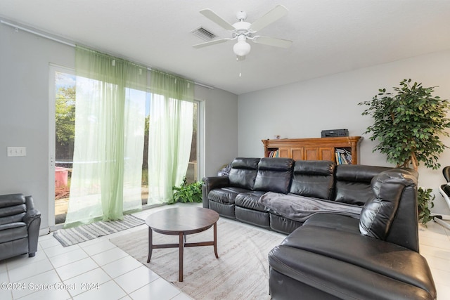 living room featuring light tile patterned floors, ceiling fan, and visible vents