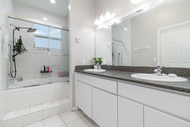 bathroom featuring double vanity, a sink, tiled shower / bath, and tile patterned floors