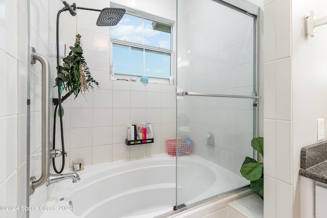 bathroom with shower / bath combination with glass door