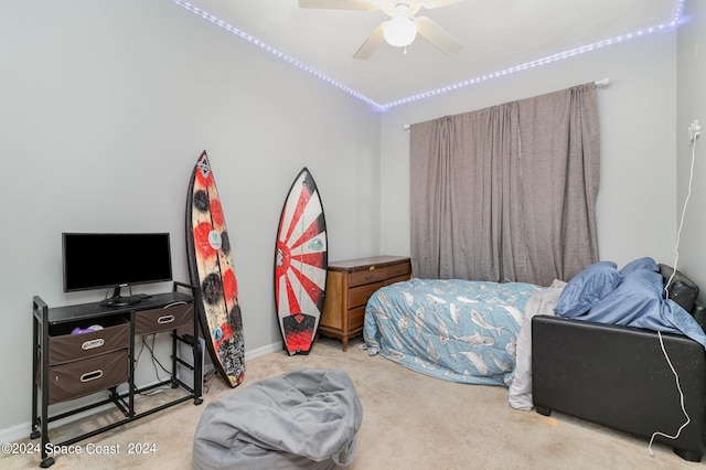 bedroom with a ceiling fan, carpet flooring, and baseboards