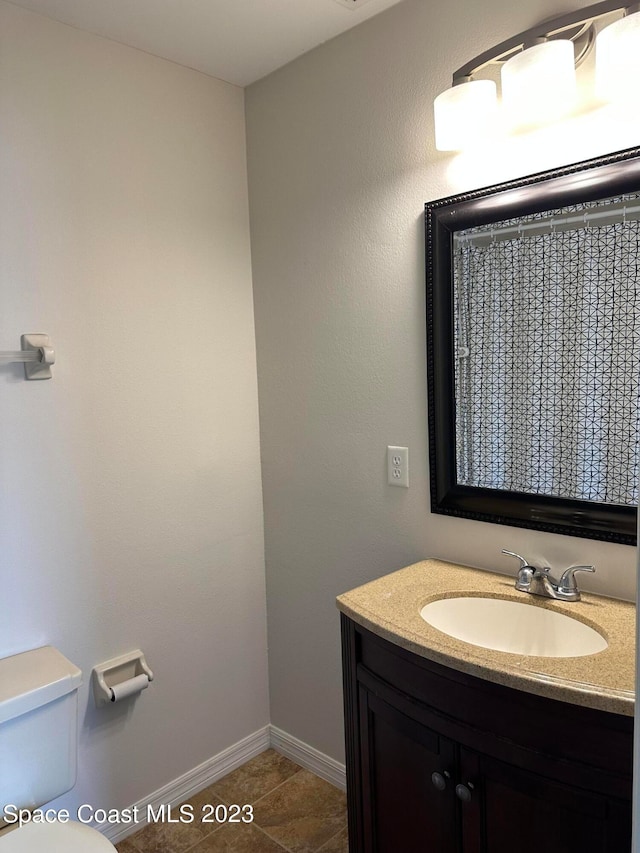 bathroom with vanity, toilet, and tile patterned floors