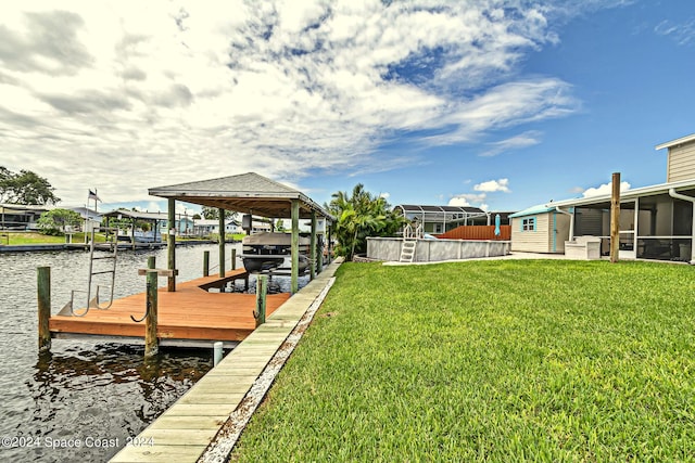 view of dock with a lawn, a water view, and boat lift