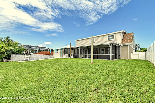 back of property featuring a lawn and a sunroom