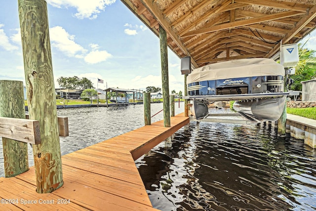 view of dock featuring a water view and boat lift