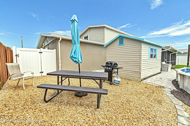 rear view of house with a patio area, a gate, and fence