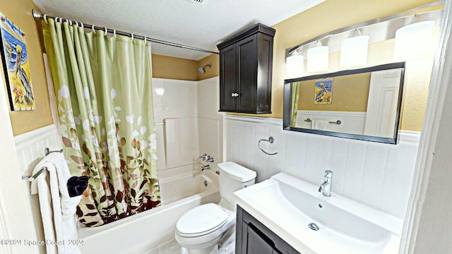 full bathroom with vanity, toilet, a textured ceiling, and shower / bathtub combination with curtain