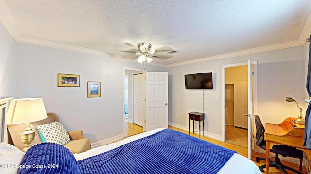 bedroom featuring a textured ceiling, crown molding, ceiling fan, and light wood-type flooring