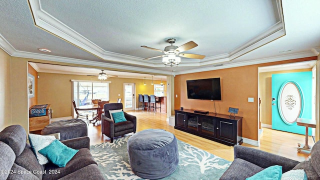 living room with ceiling fan, ornamental molding, and wood-type flooring