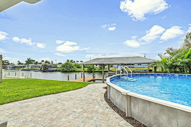 view of swimming pool featuring a water view, a lawn, and a gazebo