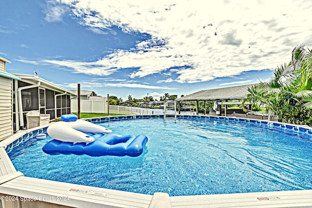 view of pool featuring a sunroom