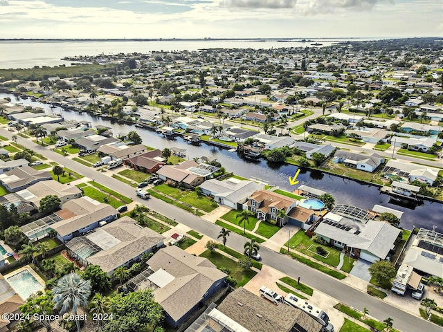 birds eye view of property with a residential view and a water view