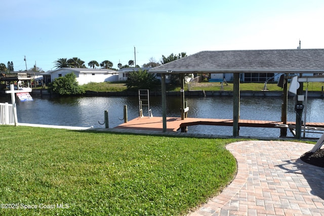 view of dock featuring a lawn, a water view, and boat lift