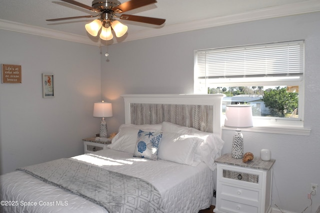 bedroom with a ceiling fan and crown molding