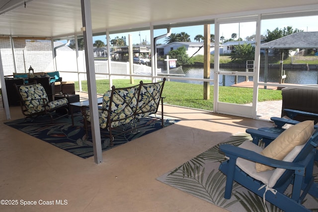 sunroom / solarium featuring a water view