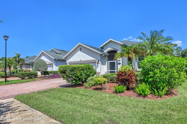 view of front of property with a front lawn and a garage