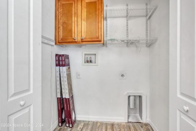 laundry area featuring light hardwood / wood-style flooring, electric dryer hookup, washer hookup, and cabinets