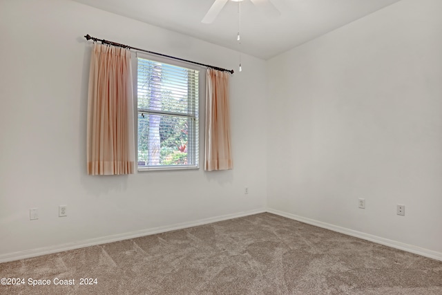 spare room featuring carpet and ceiling fan