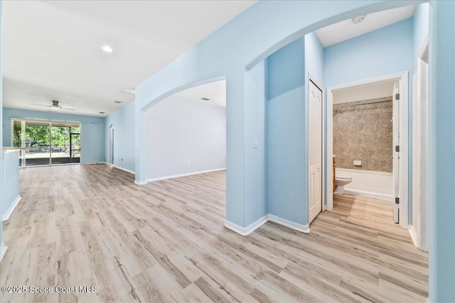 673 Remington Green Dr SE, Palm Bay, FL 32909 - interior space with arched walkways, wood finished floors, ceiling fan, and baseboards