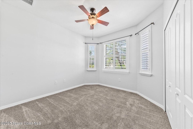 673 Remington Green Dr SE, Palm Bay, FL 32909 - empty room featuring carpet flooring, visible vents, baseboards, and a ceiling fan