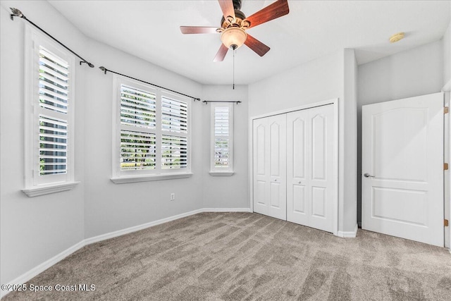 673 Remington Green Dr SE, Palm Bay, FL 32909 - unfurnished bedroom with a closet, baseboards, a ceiling fan, and carpet