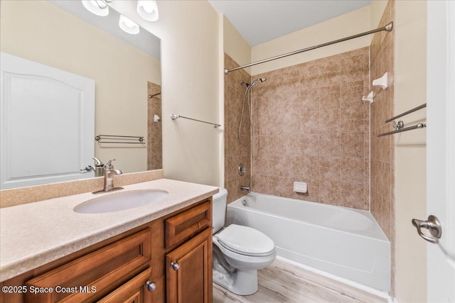 673 Remington Green Dr SE, Palm Bay, FL 32909 - bathroom featuring toilet, wood finished floors, vanity, and bathtub / shower combination