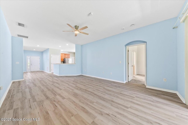 673 Remington Green Dr SE, Palm Bay, FL 32909 - unfurnished living room with light wood-type flooring, ceiling fan, baseboards, and visible vents