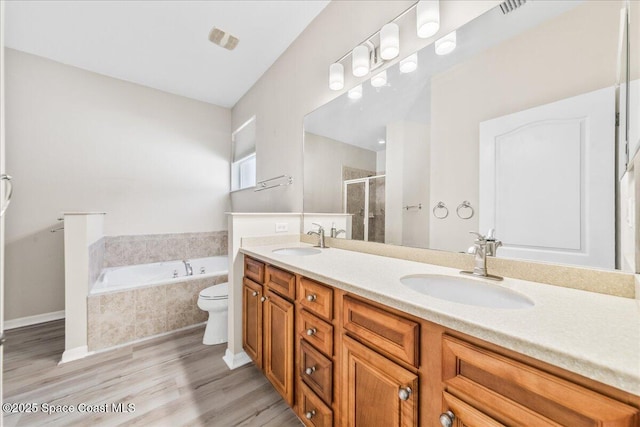 673 Remington Green Dr SE, Palm Bay, FL 32909 - full bath featuring wood finished floors, double vanity, a sink, and visible vents