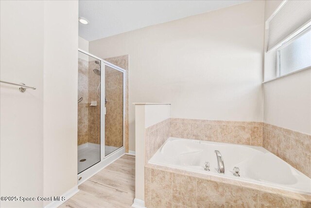 673 Remington Green Dr SE, Palm Bay, FL 32909 - full bath with a shower stall, a bath, and wood finished floors