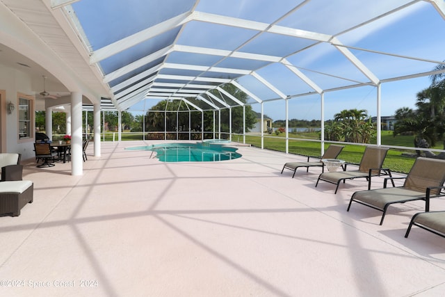 view of swimming pool featuring a lanai, a patio area, and ceiling fan