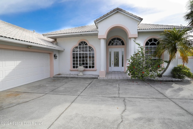 view of front of house featuring a garage and french doors