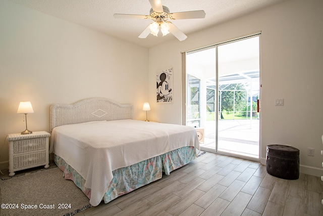 bedroom featuring ceiling fan, light hardwood / wood-style floors, a textured ceiling, and access to exterior