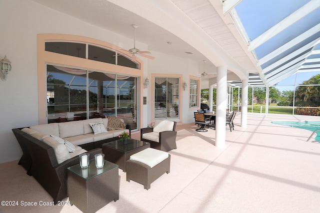 view of patio / terrace featuring glass enclosure, ceiling fan, and outdoor lounge area