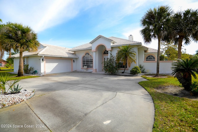 mediterranean / spanish house featuring a garage