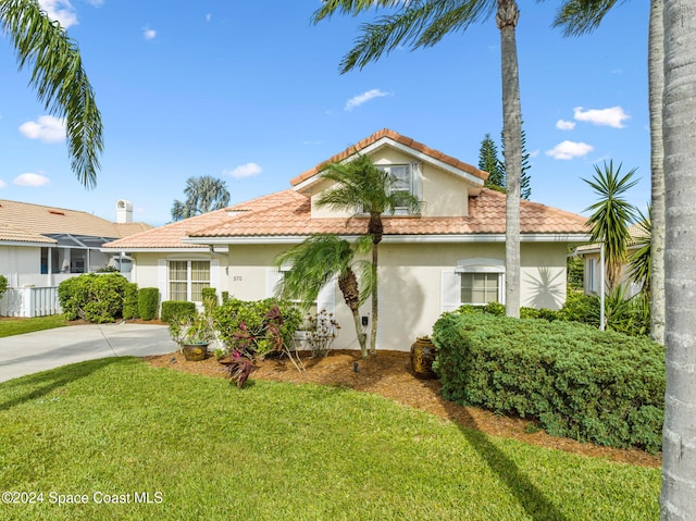 mediterranean / spanish-style home featuring a front lawn