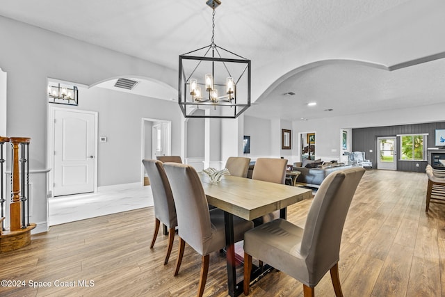 dining space with wood-type flooring and a textured ceiling